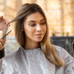 Beautiful woman getting her hair cut home by hairstylist